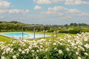 a garden with a swimming pool and flowers at Cantagrillo Boutique Resort in Vinci