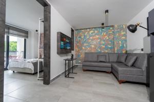 a living room with a couch and a painting on the wall at Euronova Hotels & Suites in Kemer