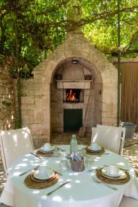 a table with a white table cloth and a fireplace at Villa Pesce in Selva di Fasano