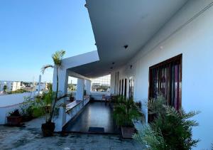 a balcony of a building with plants on it at The French Villa Elite in Puducherry