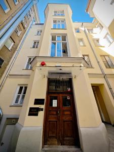 a building with a wooden door in front at Apartamenty Wilcza - City Center in Warsaw +41 photos