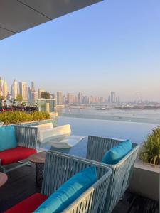 a balcony with chairs and a view of the city at Serenity Suites studio in Seven Palm corner view in Dubai