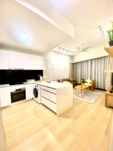 an open kitchen and living room with white cabinets at Eastern Suites Star KLcc in Kuala Lumpur