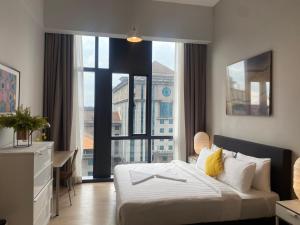 a bedroom with a bed and a large window at Eastern Suites Star KLcc in Kuala Lumpur +153 photos