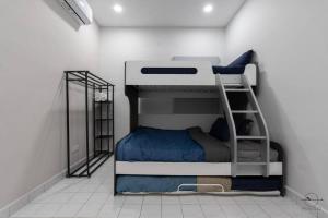 a bedroom with two bunk beds in a room at [Party House Megah Ria] #65'Tv #1600sqf Open space in Masai