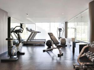 a gym with several exercise equipment in a room at Novotel Lyon Confluence in Lyon