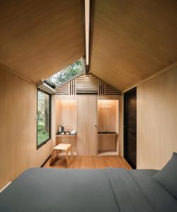 a bedroom of a house with a large window at Bobocabin Pacet, Mojokerto in Claket