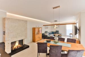 a living room with a table and a fireplace at Landhaus Wreechen mit Sauna in Putbus