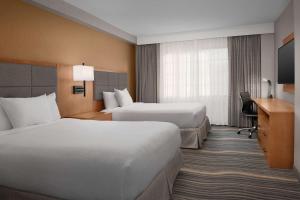 Postel nebo postele na pokoji v ubytování Embassy Suites La Quinta Hotel & Spa
