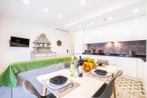a kitchen and dining room with a table and chairs at Apartment Carvoeiro By The Sea 1 by Algarve Vacation in Carvoeiro +42 photos
