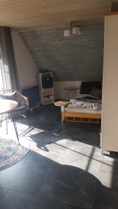 a bedroom with a bed and a tv and a table at 1 Zimmer Appartement mit Bad in Königsbrunn