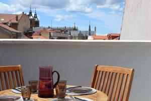 a table with a jug and glasses on a balcony at La Aduana The Lodging Experience in Astorga