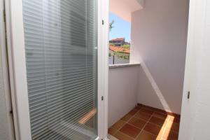a room with a glass door with a view of a balcony at Villas Corinthia in Baška