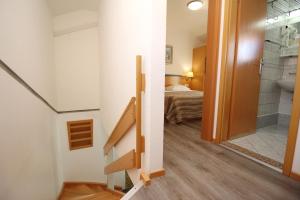 a bathroom with a shower and a bed in a room at Villas Corinthia in Baška