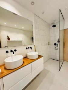 two sinks in a bathroom with a mirror at Hotel Hoofd & Vondel in Amsterdam