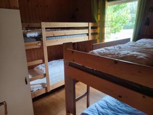 two bunk beds in a room with a window at Strandheim Two-Bedroom Cottage in Birkeland