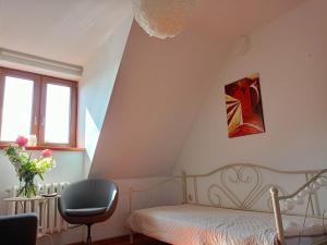 a bedroom with a bed and a chair at Kazimierz City Center Senatorska in Kazimierz Dolny