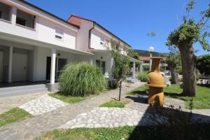 a orange fire hydrant in front of a house at Villas Corinthia in Baška