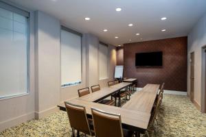 a conference room with tables and chairs and a tv at Homewood Suites by Hilton Atlanta Buckhead Pharr Road in Atlanta