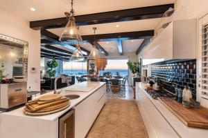 a large kitchen with a view of the ocean at Clifton Ezulwini in Cape Town