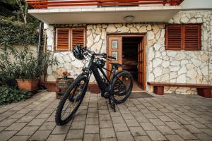 a bike parked in front of a house at Cozy family place 'Hiša Grozdek' - Gruškovec 40A in Gruškovec