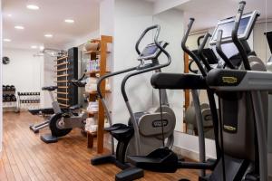 a gym with treadmills and elliptical machines at Grand Hotel Vilnius, Curio Collection by Hilton in Vilnius