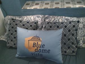 a blue dome pillow with a blue dome insignia on it at Cute and characterful townhouse in Oliva