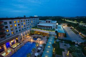 an overhead view of a hotel with a pool at night at Novotel Hyderabad Airport in Hyderabad