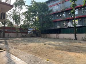 an empty parking lot in front of a building at Palaash Bon in Guwahati