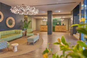 a lobby with a couch and chairs and a table at Hotel Acores Lisboa in Lisbon