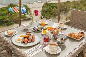 a table with breakfast foods and coffee on the beach at Braye Beach Hotel, Alderney in Alderney +47 photos
