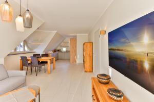 a living room with a couch and a table at Landhaus Wreechen mit Dachterrasse in Putbus