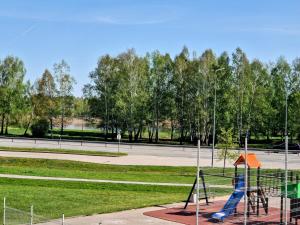 a playground with a blue slide in a park at Butas šalia parko in Radviliškis
