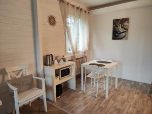 a small kitchen with a table and a table and chairs at La Maison de Boyeux in Châtillon