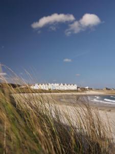 a view of a beach with buildings in the background at Braye Beach Hotel in Braye