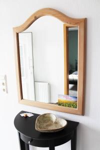 a hat on a table in front of a mirror at Tor zum Bodensee in Stockach +16 photos