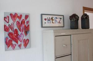 a room with two framed hearts on the wall at Tor zum Bodensee in Stockach