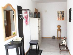 a living room with a table and a mirror at Tor zum Bodensee in Stockach
