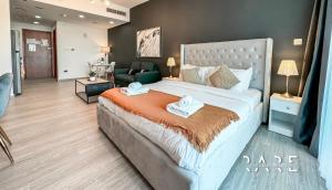 a bedroom with a large bed and a living room at Rare Holiday Homes - Studio in Crescent Tower near City Center Mall - R712 IMPZ in Dubai