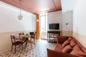 a living room with a couch and a table at Flat 13 in Sorrento