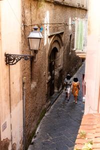 two people walking down a street in an alley at Flat 13 in Sorrento