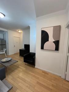 a living room with a couch and a painting on a wall at Apartment in New York By Central Park in New York