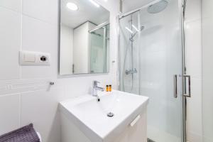 a white bathroom with a sink and a shower at Trendy Homes Aguadulce Bay in Aguadulce +11 photos