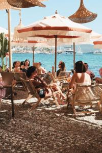 a group of people sitting in chairs on a beach at Churchill Townhouse in Bodrum City