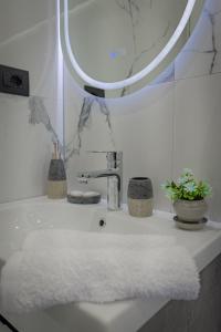 a bathroom sink with a mirror and a white towel at Shena The Farm Boutique in Mesopotam +139 photos