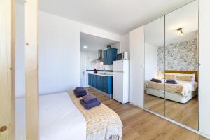 a kitchen with blue cabinets and a white refrigerator at Trendy Homes Aguadulce Bay in Aguadulce