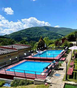 two swimming pools with mountains in the background at GWAREK Centrum Wypoczynkowe in Ustroń