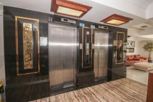 a lobby with two elevators in a building at MOSTAR HOTEL ANTALYA in Antalya
