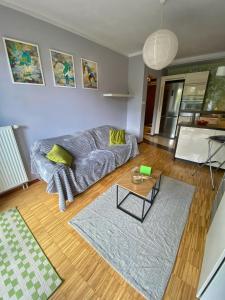 a living room with a couch and a table at Apartament Mosiężna & Taras & Free Parking & Self Check in 24H in Wrocław