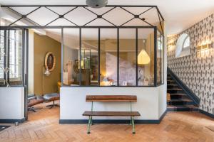 a room with a bench and a staircase at Les Gargouilles - House with crazy charm heated pool and garden in Caluire-et-Cuire